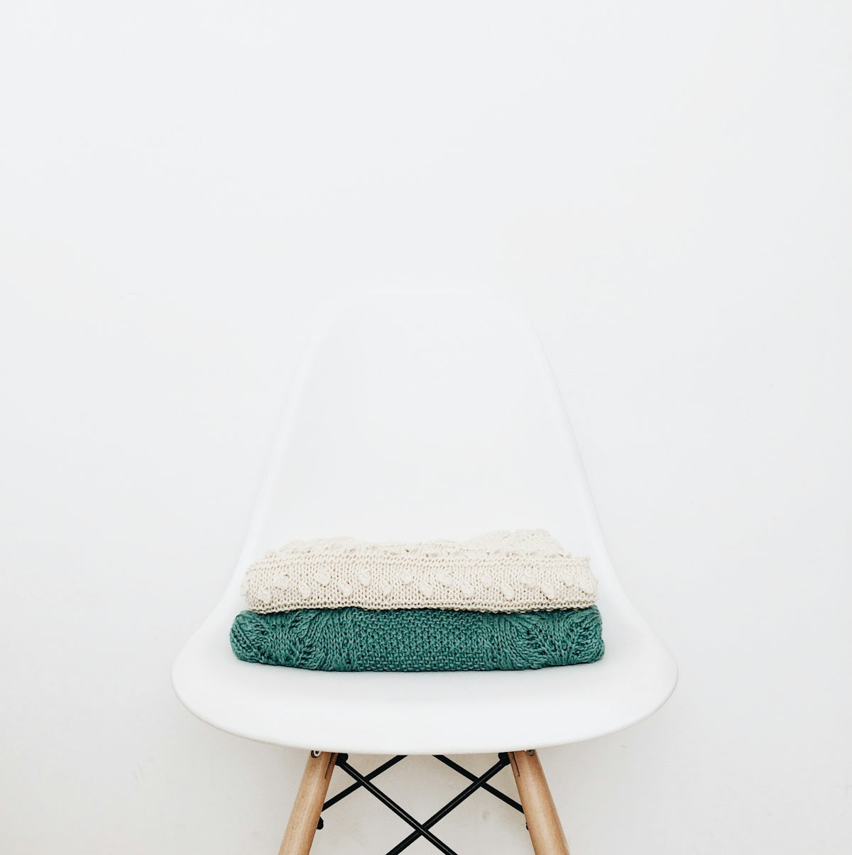 white and teal textile on white stool