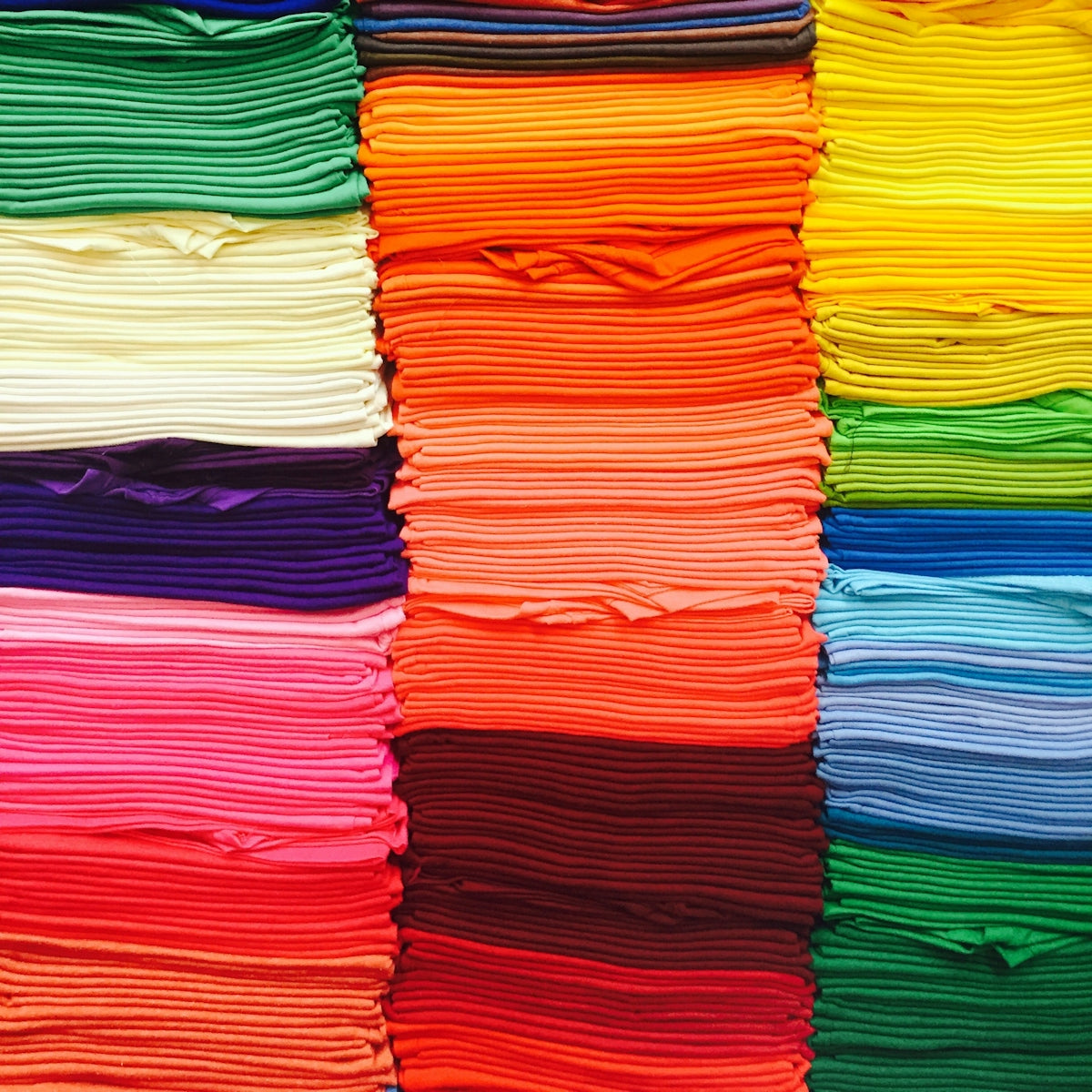 pink green blue and yellow textile