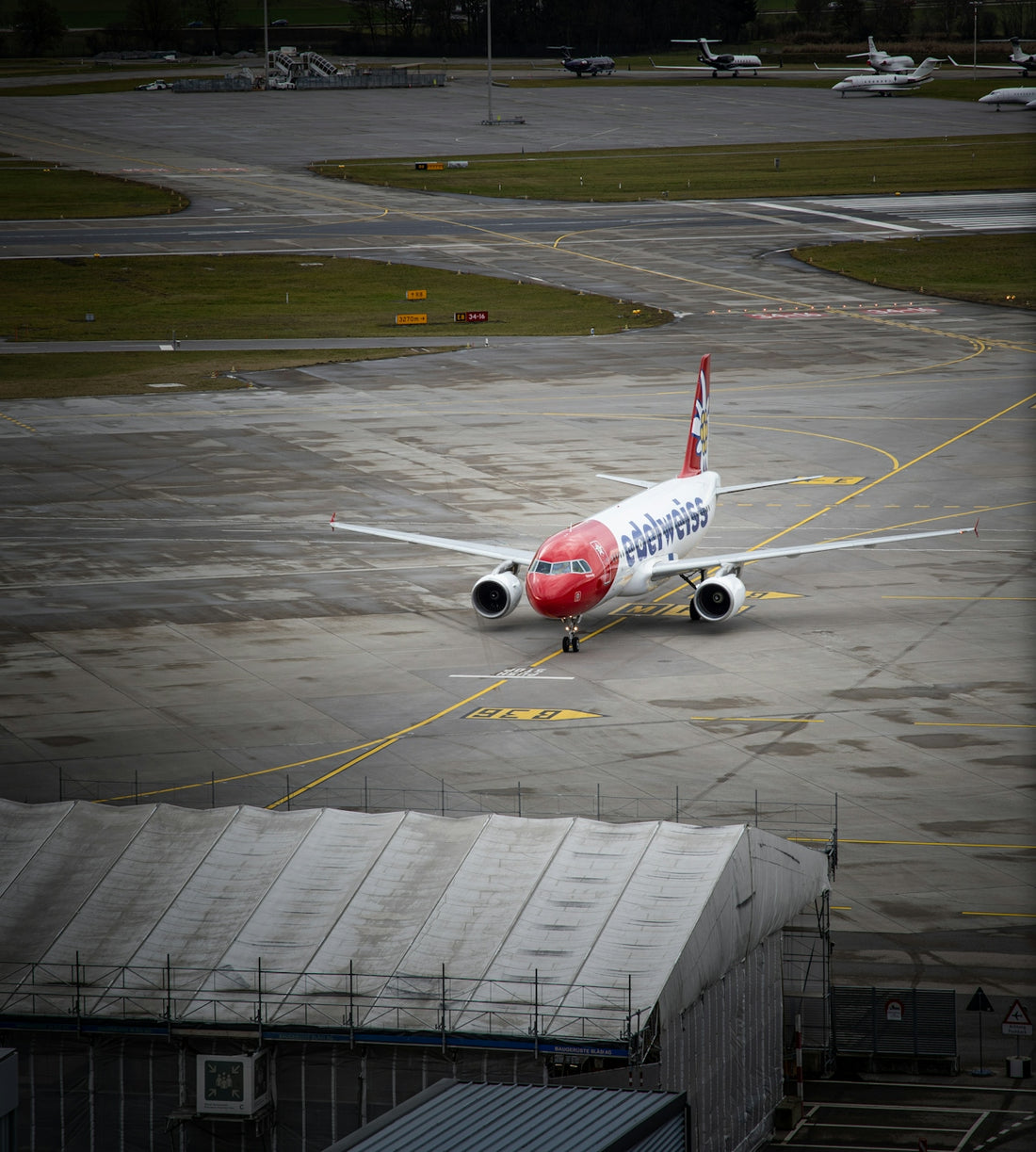 white and red airplane on airport during daytime
