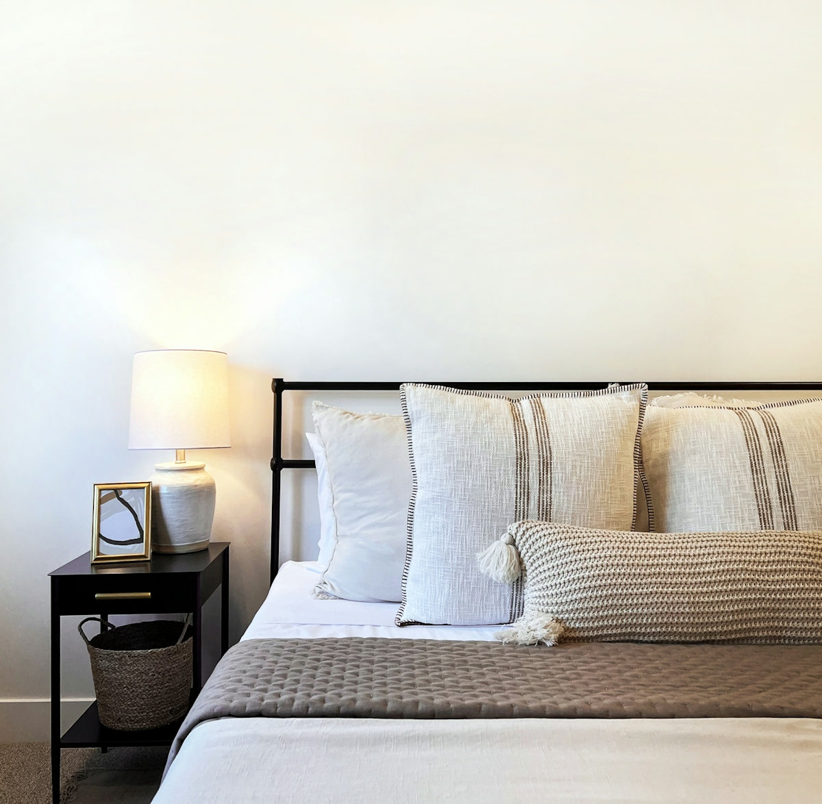 a bed with a basket and pillows