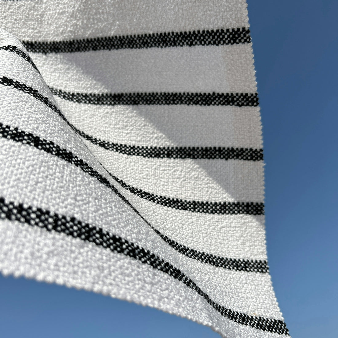 a black and white striped fabric flying in the air