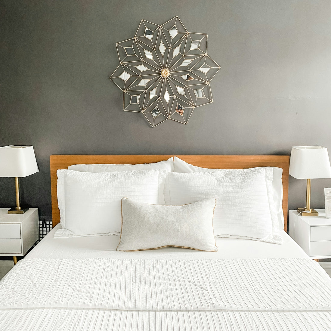 a bed with a white bedspread and pillows