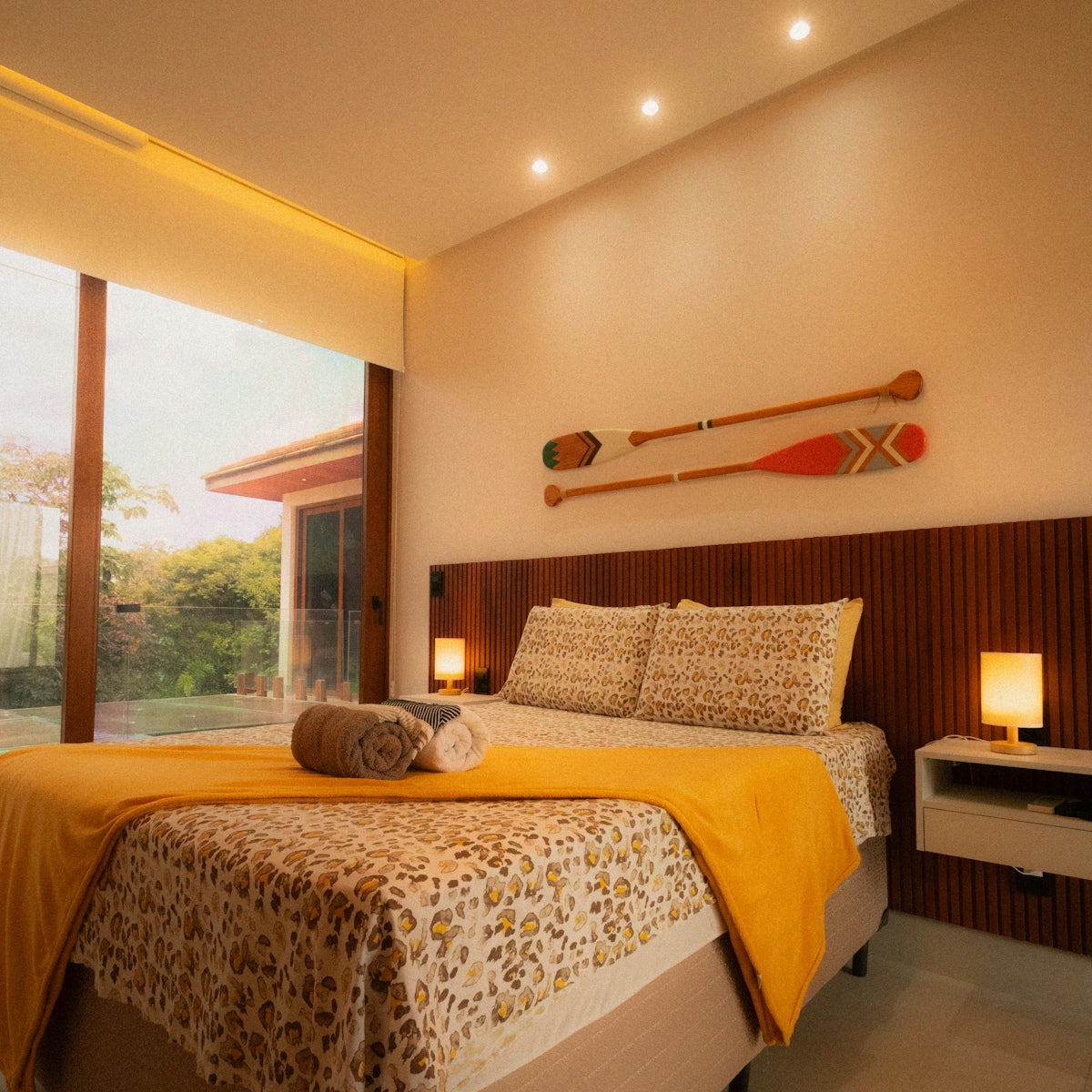 Cozy bedroom with large window and oars on-wall paddles