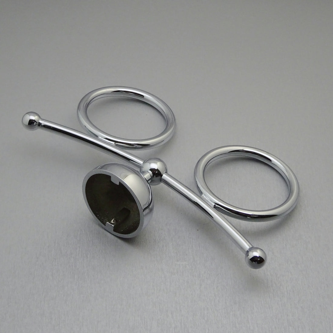 Two chrome rings with a central connecting rod.