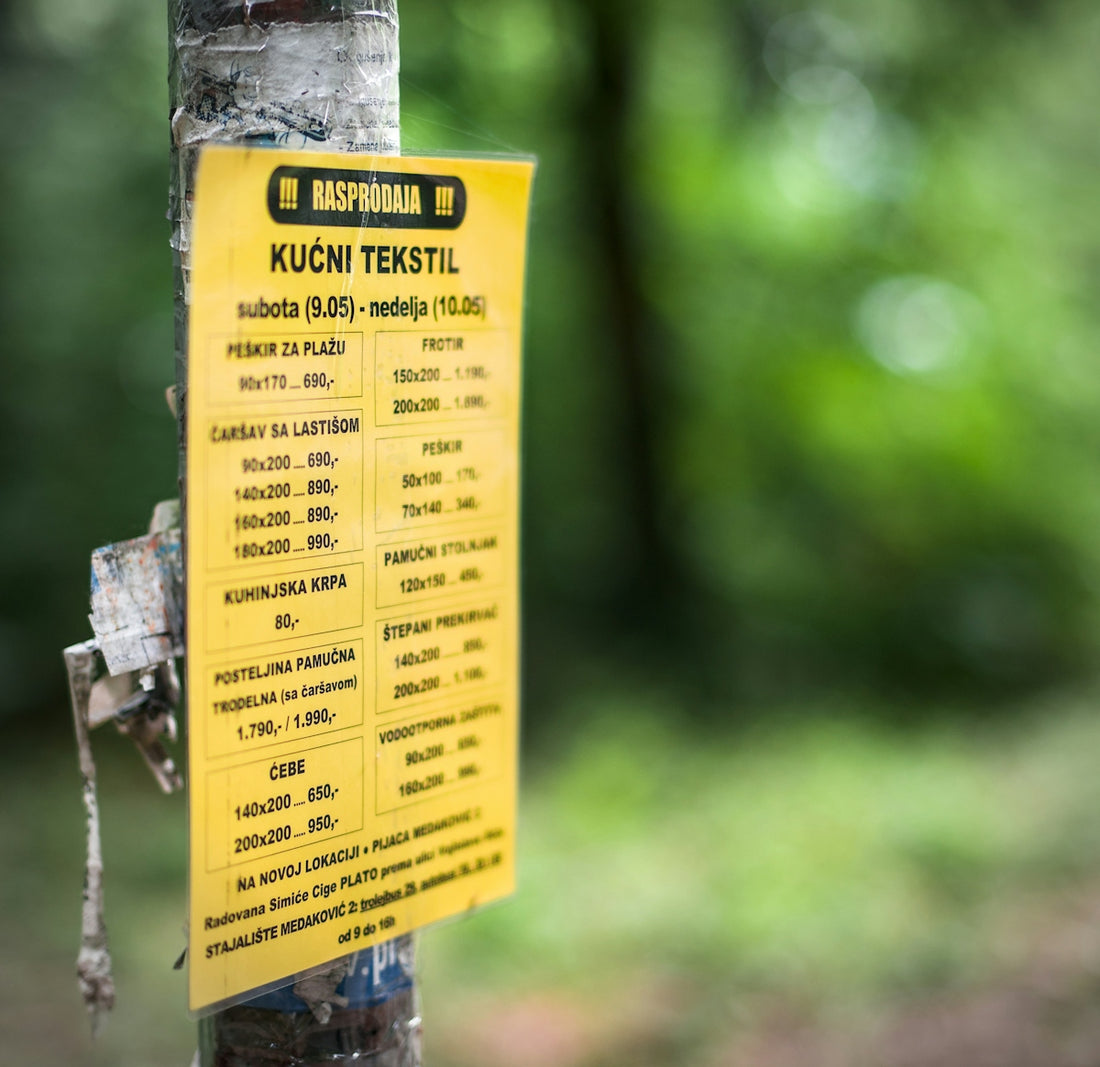Yellow sign with text attached to a tree