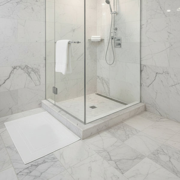 White bath mat at the standing shower