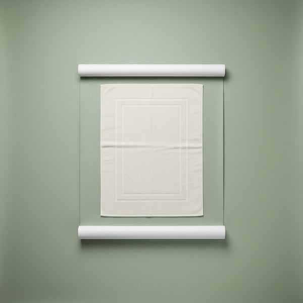 White textured bath mat on a green background