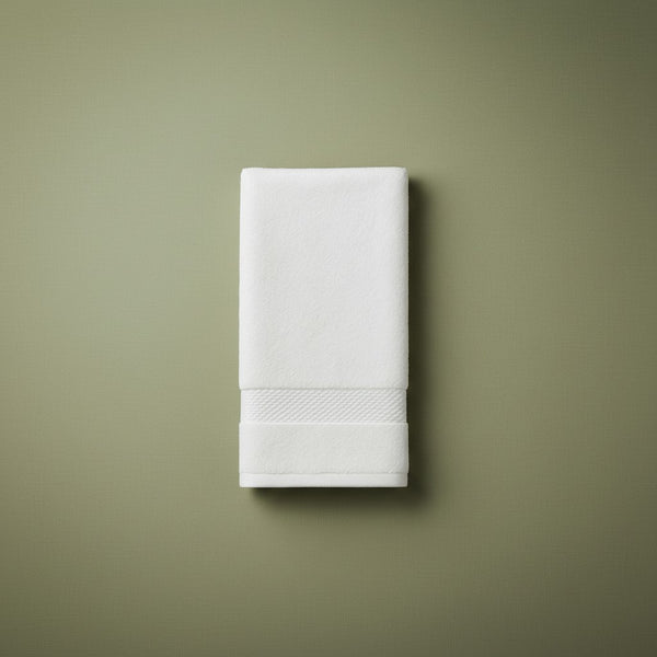 White folded hand towel on a green background